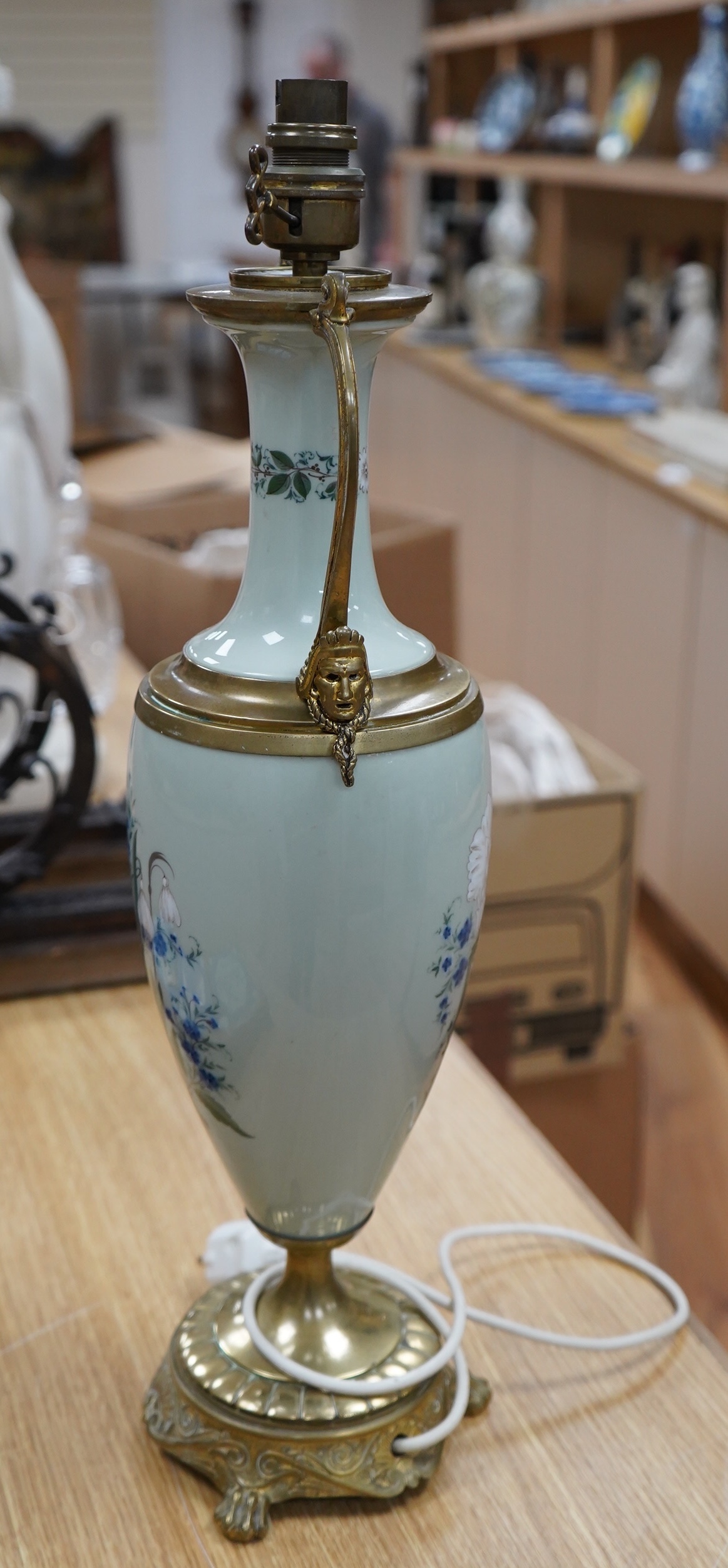 A late 19th century French celadon green glazed lamp, painted with flowers, fitted as a lamp, 56cm high overall. Condition - good